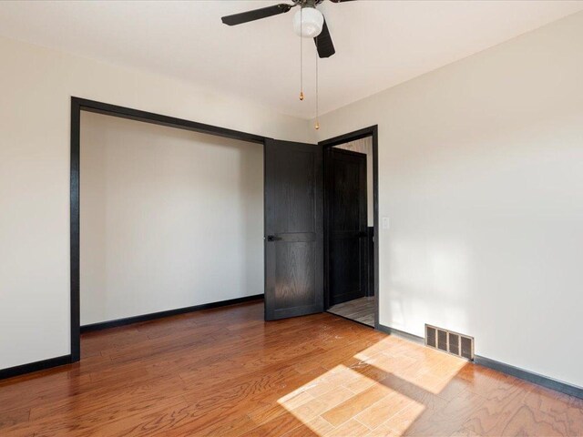 14122 13th Ave SW, Sylvan Twp, MN 56473 - unfurnished room featuring wood finished floors, ceiling fan, and baseboards