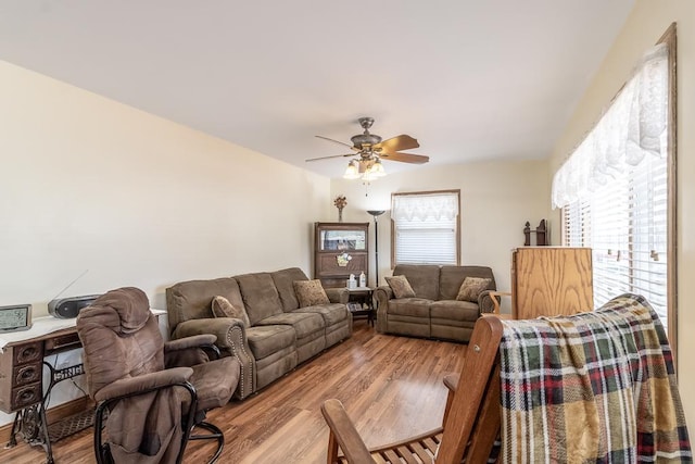 living area with wood finished floors and ceiling fan