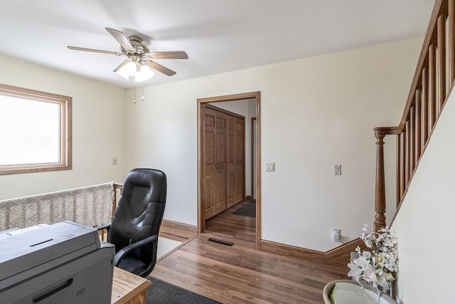 office area with ceiling fan, baseboards, wood finished floors, and visible vents