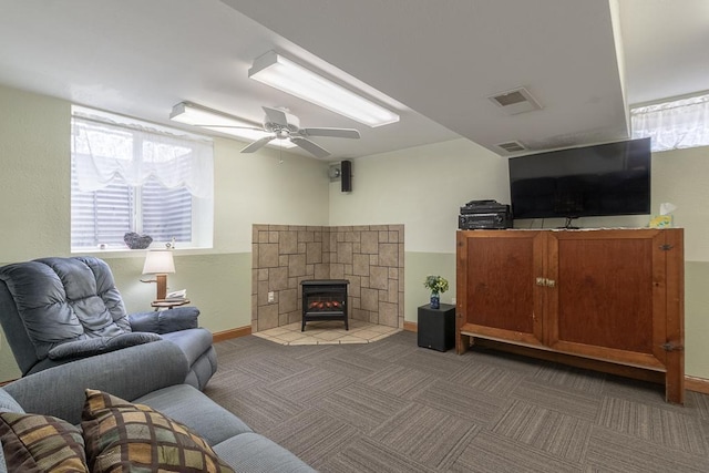 living area with carpet, visible vents, a ceiling fan, and baseboards