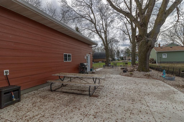 view of home's exterior with fence and a patio
