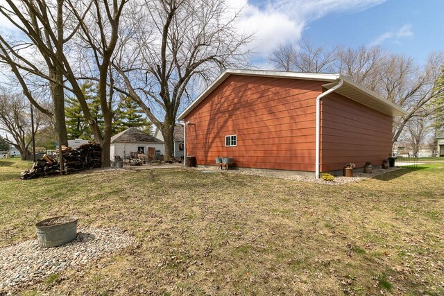 view of side of home with a lawn