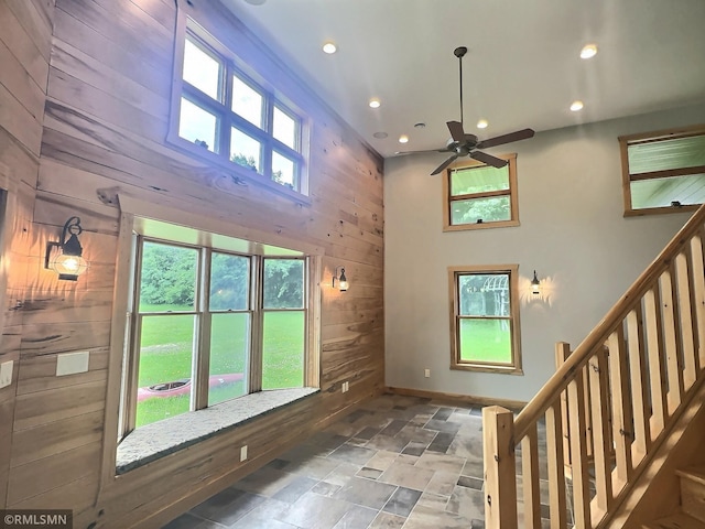 7861 Greer Ave NW, Maple Lake, MN 55358 - entrance foyer featuring wood walls, stone finish floors, recessed lighting, a ceiling fan, and stairway