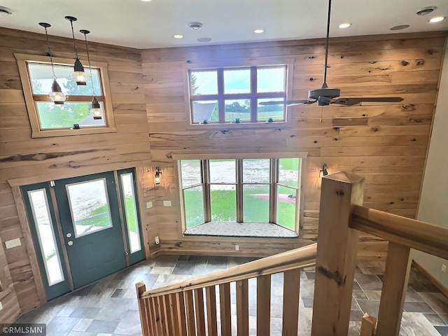 7861 Greer Ave NW, Maple Lake, MN 55358 - foyer entrance with wood walls, a ceiling fan, light stone finish flooring, healthy amount of natural light, and recessed lighting