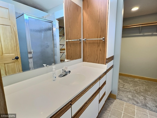 7861 Greer Ave NW, Maple Lake, MN 55358 - bathroom featuring a walk in closet, a shower stall, vanity, and baseboards