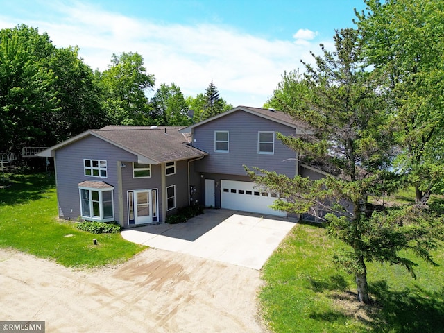 7861 Greer Ave NW, Maple Lake, MN 55358 - view of front of home featuring concrete driveway, a garage, and a front lawn