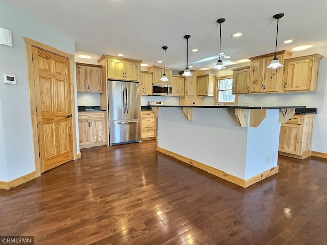7861 Greer Ave NW, Maple Lake, MN 55358 - kitchen with stainless steel appliances, dark countertops, dark wood-style floors, recessed lighting, and light brown cabinetry
