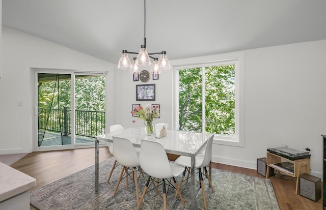 613 Cromwell Ave, Saint Paul, MN 55104 - dining area featuring a chandelier, plenty of natural light, wood finished floors, lofted ceiling, and baseboards