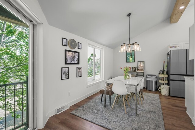 613 Cromwell Ave, Saint Paul, MN 55104 - dining space featuring plenty of natural light, a chandelier, vaulted ceiling, dark wood-style floors, and baseboards