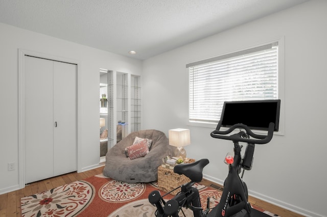 613 Cromwell Ave, Saint Paul, MN 55104 - workout room featuring wood-type flooring, baseboards, recessed lighting, and a textured ceiling