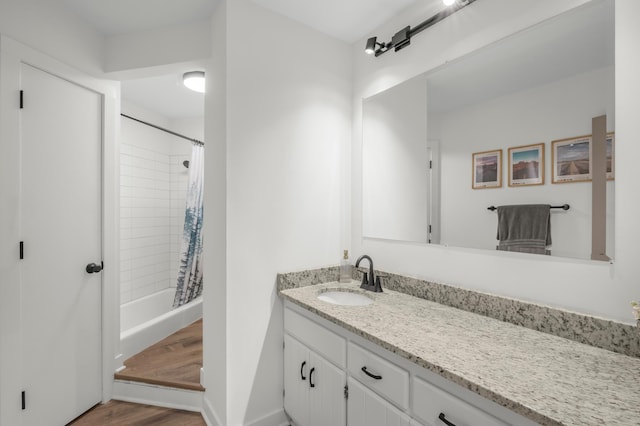 613 Cromwell Ave, Saint Paul, MN 55104 - full bathroom with vanity, wood finished floors, and shower / bath combo with shower curtain