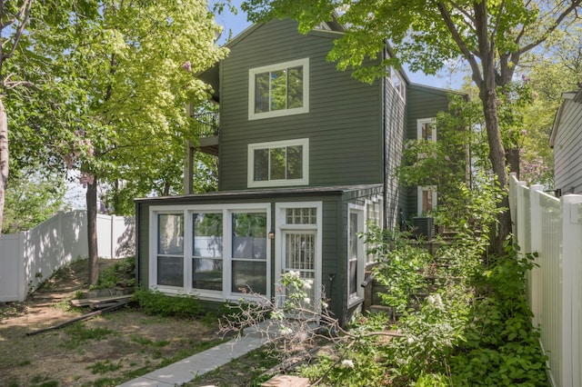 613 Cromwell Ave, Saint Paul, MN 55104 - rear view of property featuring a sunroom, a fenced backyard, and a balcony