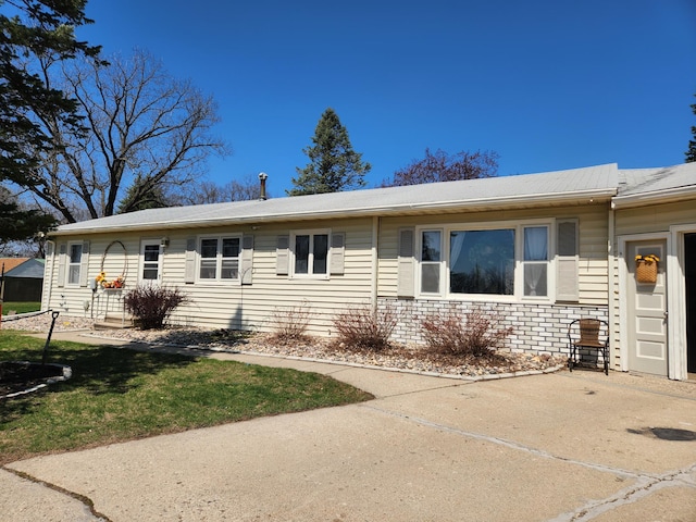 ranch-style house with brick siding and a front lawn
