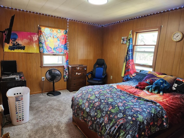 bedroom featuring wood walls and carpet