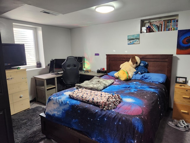 carpeted bedroom featuring visible vents