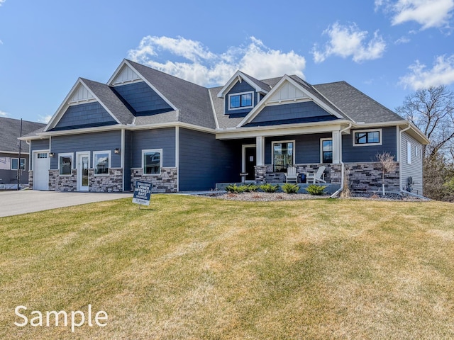 craftsman inspired home with board and batten siding, a porch, stone siding, and a front lawn