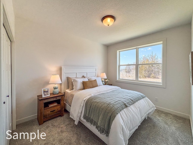 carpeted bedroom with baseboards and a textured ceiling