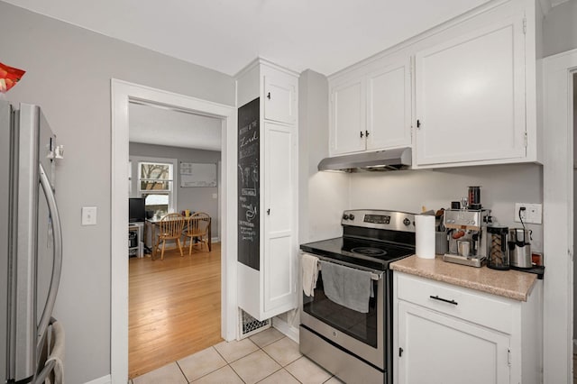 kitchen featuring light tile patterned floors, appliances with stainless steel finishes, light countertops, white cabinets, and under cabinet range hood