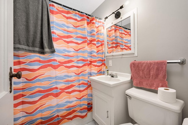 full bathroom with toilet, vanity, and curtained shower