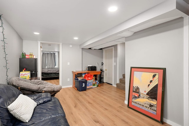living room featuring light wood-type flooring, baseboards, recessed lighting, and stairway