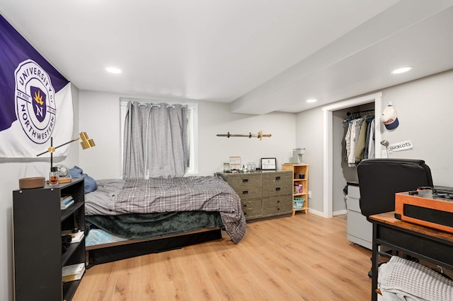 bedroom with baseboards, wood finished floors, and recessed lighting