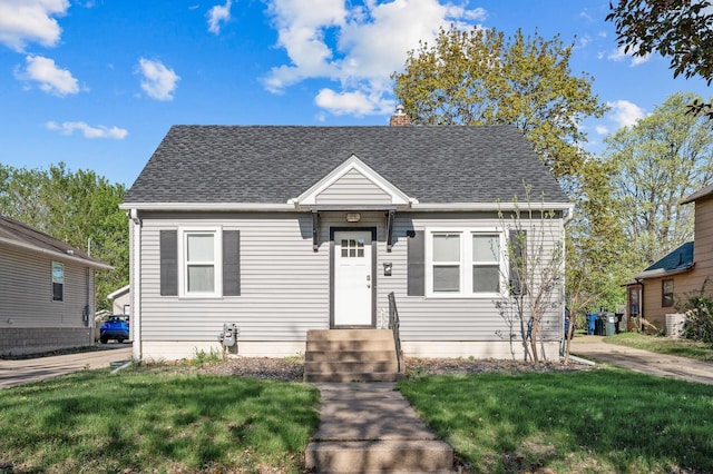 3806 Jackson St NE, Columbia Heights, MN 55421 - view of front of house with roof with shingles, a front lawn, and a chimney