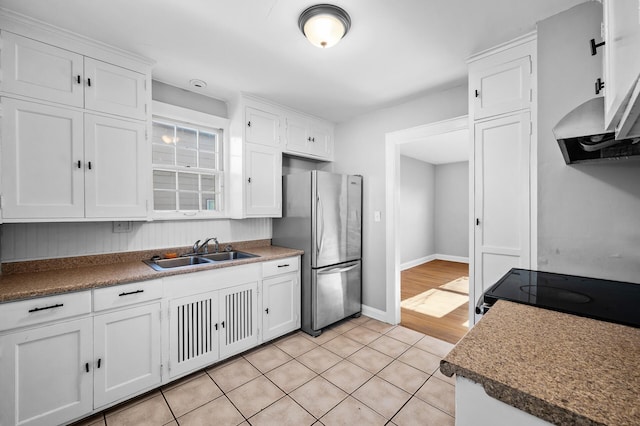 3806 Jackson St NE, Columbia Heights, MN 55421 - kitchen featuring freestanding refrigerator, a sink, and white cabinetry