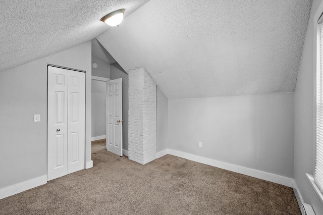 3806 Jackson St NE, Columbia Heights, MN 55421 - additional living space with a textured ceiling, carpet, a baseboard heating unit, lofted ceiling, and baseboards