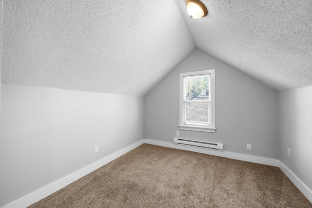 3806 Jackson St NE, Columbia Heights, MN 55421 - additional living space featuring a baseboard heating unit, a textured ceiling, carpet, vaulted ceiling, and baseboards