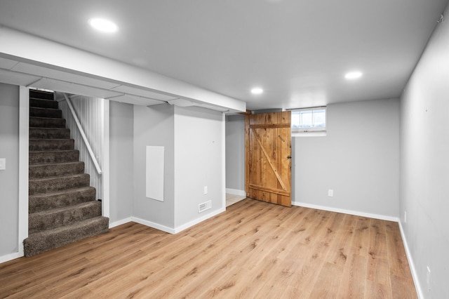 3806 Jackson St NE, Columbia Heights, MN 55421 - below grade area with wood finished floors, stairs, baseboards, and recessed lighting