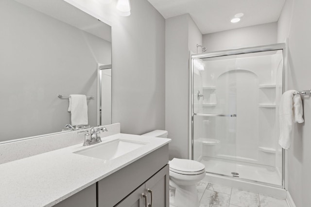 full bathroom featuring a shower stall, toilet, marble finish flooring, vanity, and recessed lighting