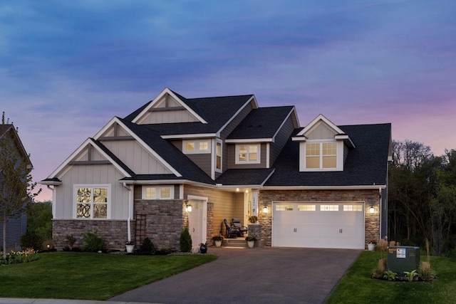 view of front of house featuring board and batten siding, stone siding, driveway, and a front yard