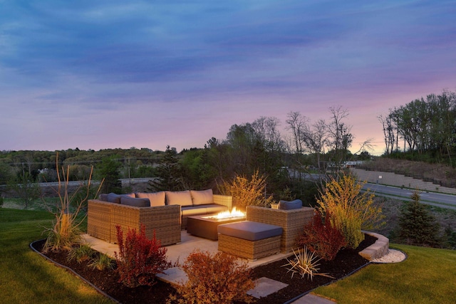 view of patio featuring an outdoor living space with a fire pit
