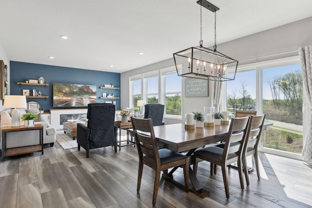 dining space with a chandelier, wood finished floors, and recessed lighting