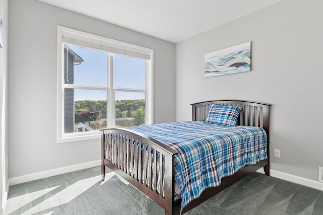 bedroom featuring carpet floors and baseboards