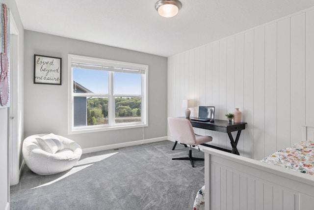 carpeted bedroom with baseboards and an office area