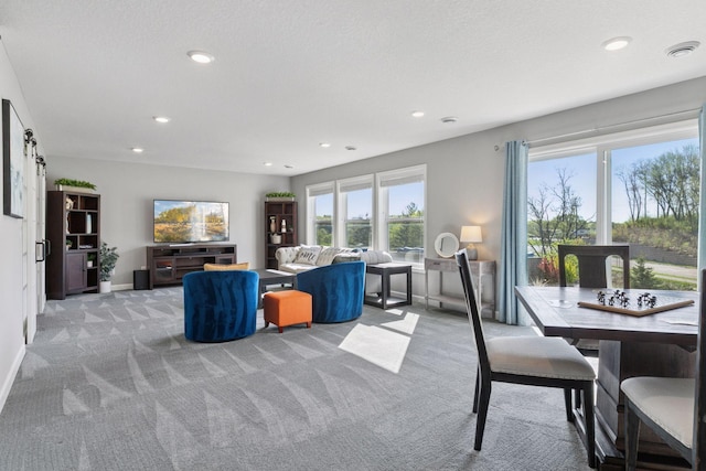 living room featuring light colored carpet, recessed lighting, and baseboards