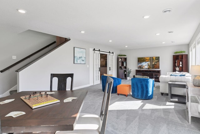 dining area with a barn door, carpet flooring, recessed lighting, stairs, and baseboards