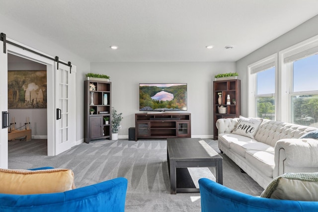 carpeted living area with a barn door, baseboards, and recessed lighting