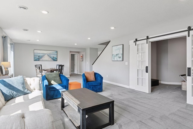 living area with a barn door, carpet flooring, recessed lighting, and baseboards