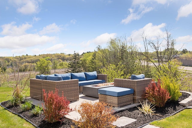 view of patio / terrace with an outdoor living space with a fire pit