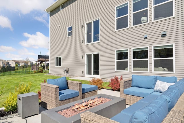back of property featuring an outdoor living space with a fire pit and a patio area