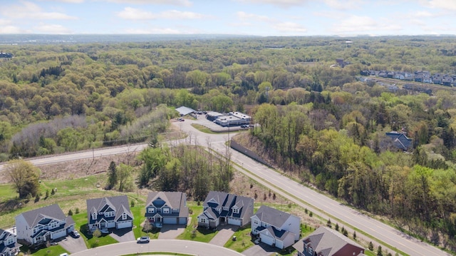 aerial perspective of suburban area featuring a heavily wooded area