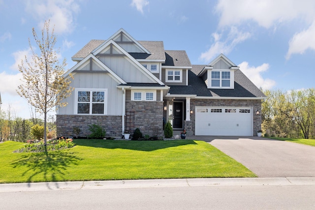 craftsman inspired home with stone siding, board and batten siding, driveway, a front lawn, and roof with shingles
