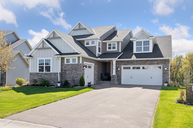 craftsman inspired home featuring board and batten siding, stone siding, driveway, and a front lawn
