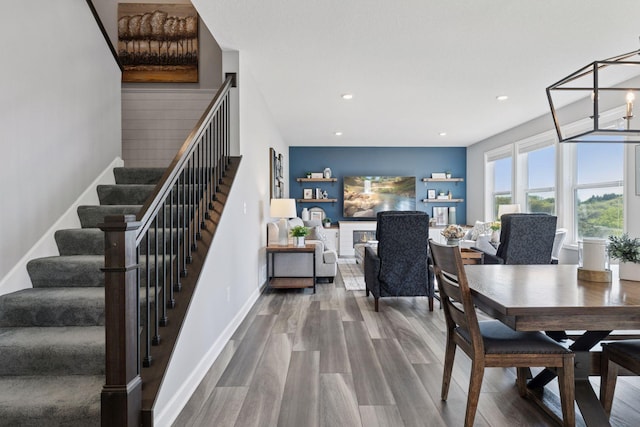 dining room featuring stairway, recessed lighting, and wood finished floors