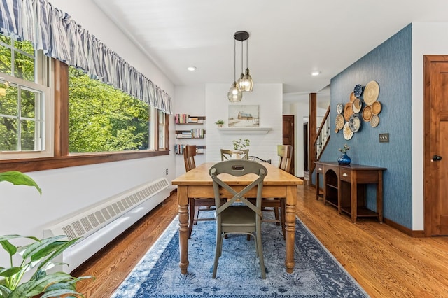 319 Meadow Ln, Benson, MN 56215 - dining room featuring plenty of natural light, wood finished floors, baseboard heating, stairway, and recessed lighting