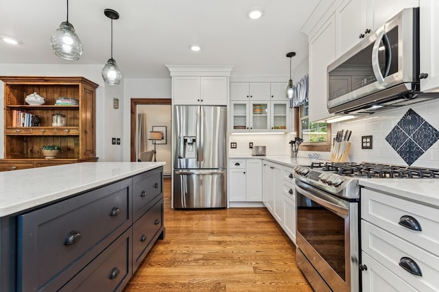 319 Meadow Ln, Benson, MN 56215 - kitchen with appliances with stainless steel finishes, white cabinets, backsplash, and recessed lighting
