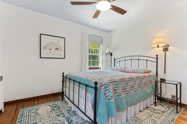319 Meadow Ln, Benson, MN 56215 - bedroom with baseboards, wood finished floors, and ceiling fan