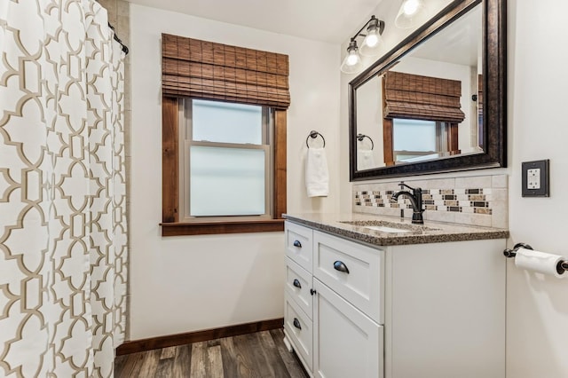 319 Meadow Ln, Benson, MN 56215 - bathroom with wood finished floors, vanity, backsplash, baseboards, and a shower with curtain